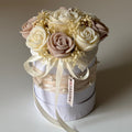 Decorative box with flowers and ribbons on a plain background